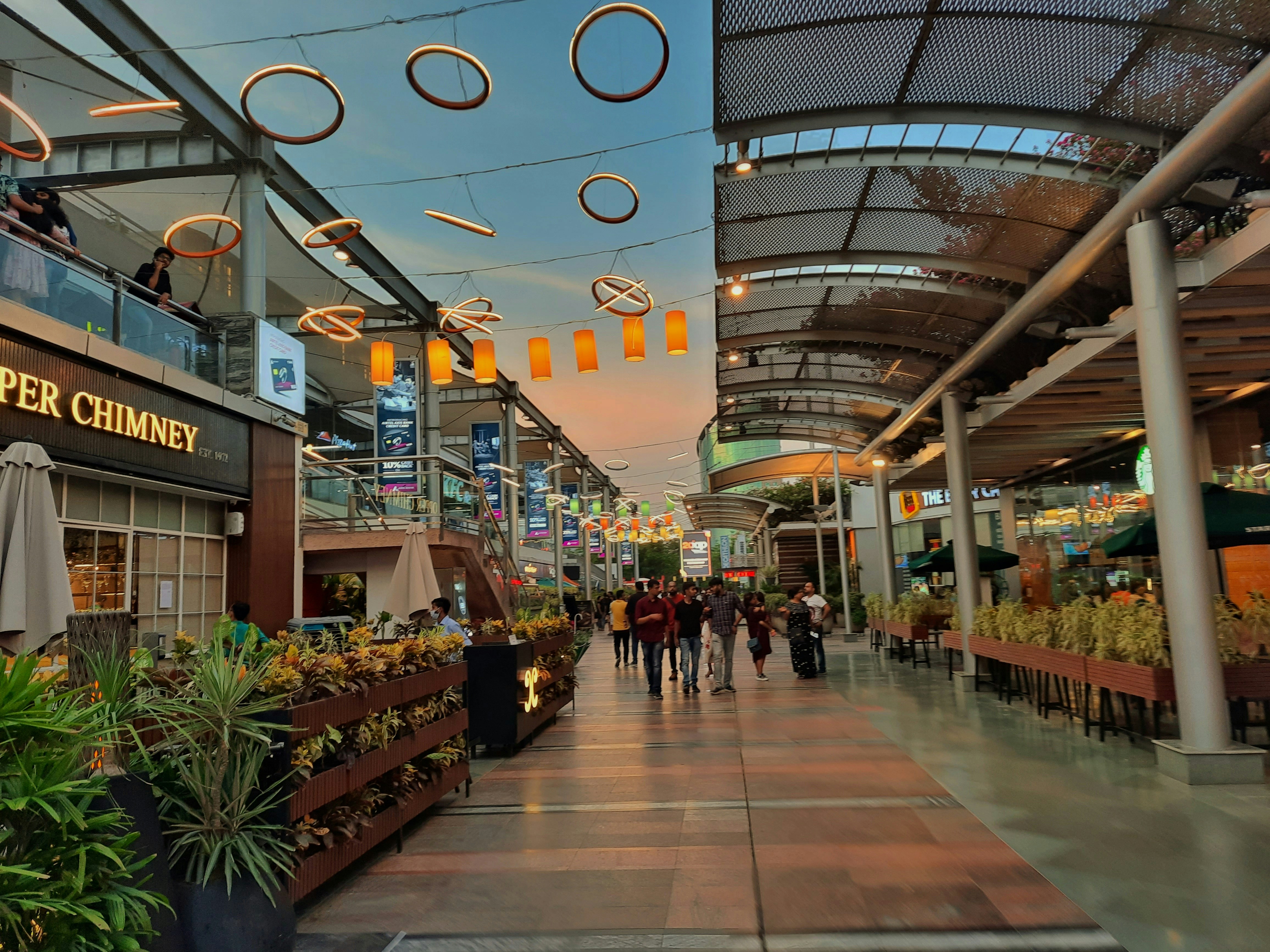 a group of people walking through a shopping mall