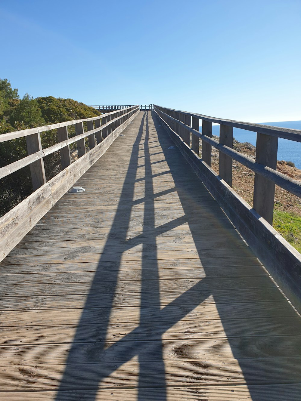 a wooden bridge with a railing