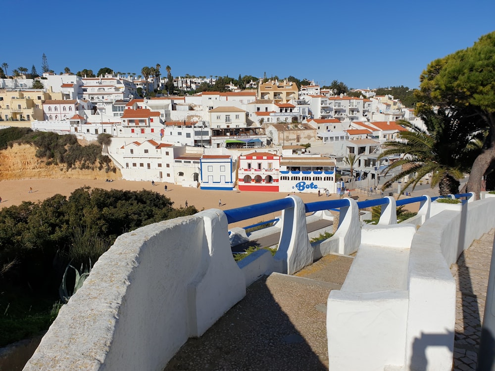 a white fence with a town in the background