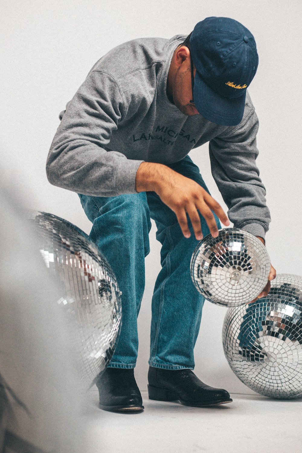 a man squatting down with a basketball in his hand