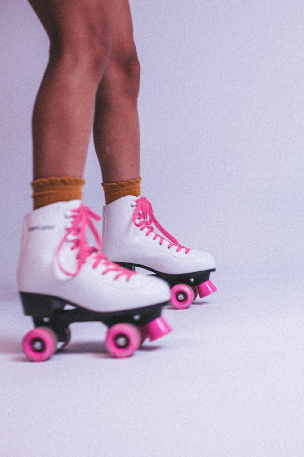 a person's legs wearing pink and white shoes