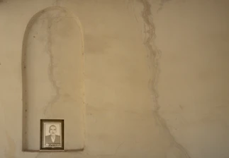 A moody shot of a signed photo print displayed against a backdrop of black velvet.