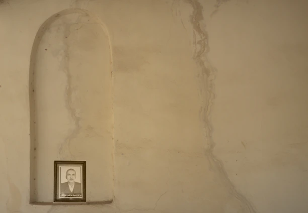 Close-up of a beautifully captured portrait photo displayed against a rustic wall.