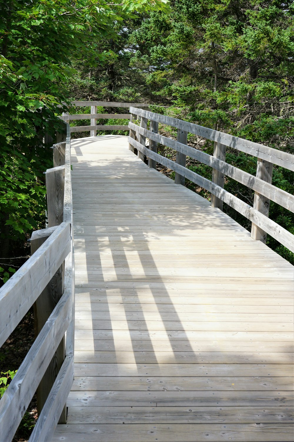 a wooden bridge with railings
