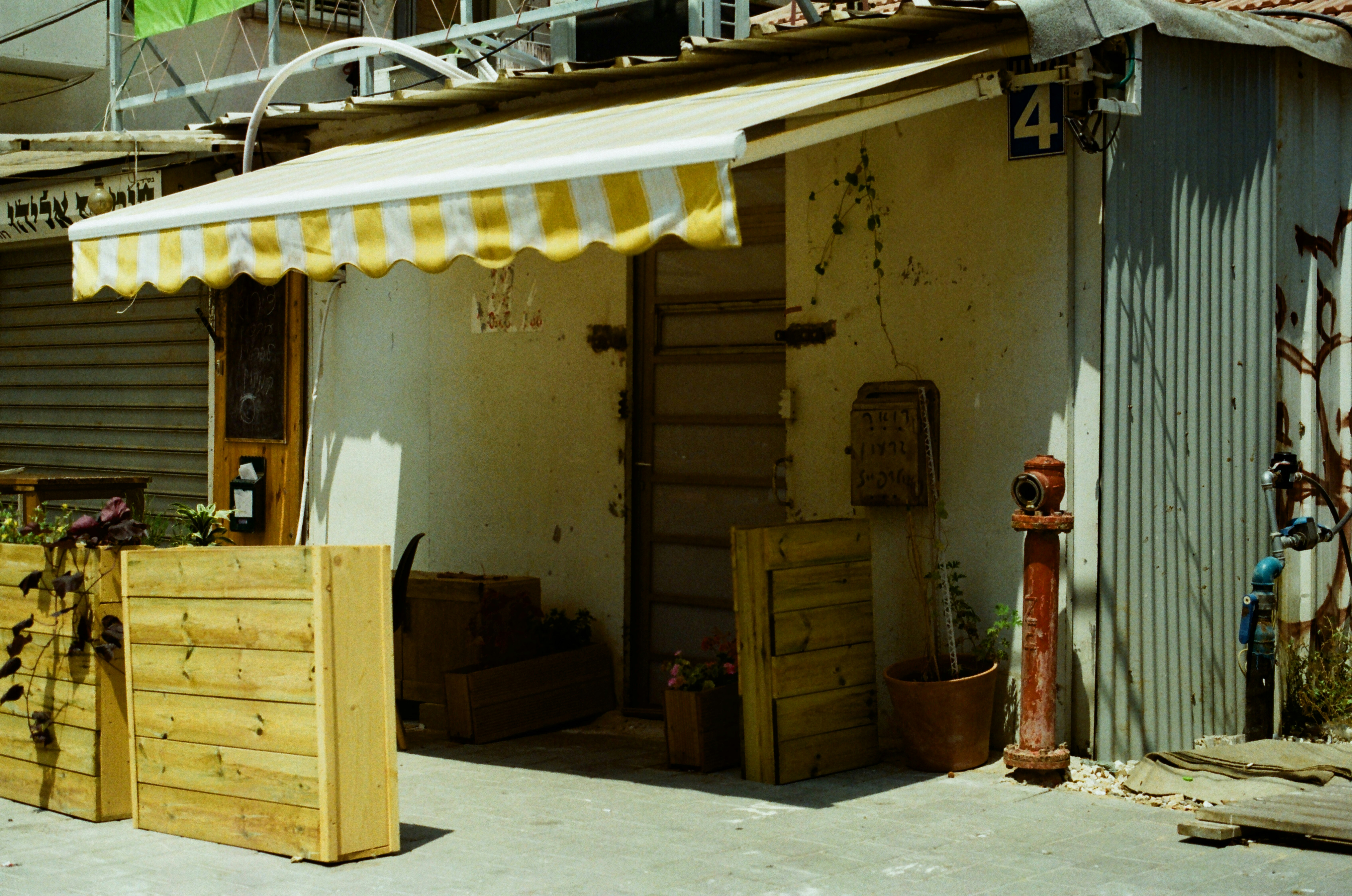 Small timber kiosk with a striped awning