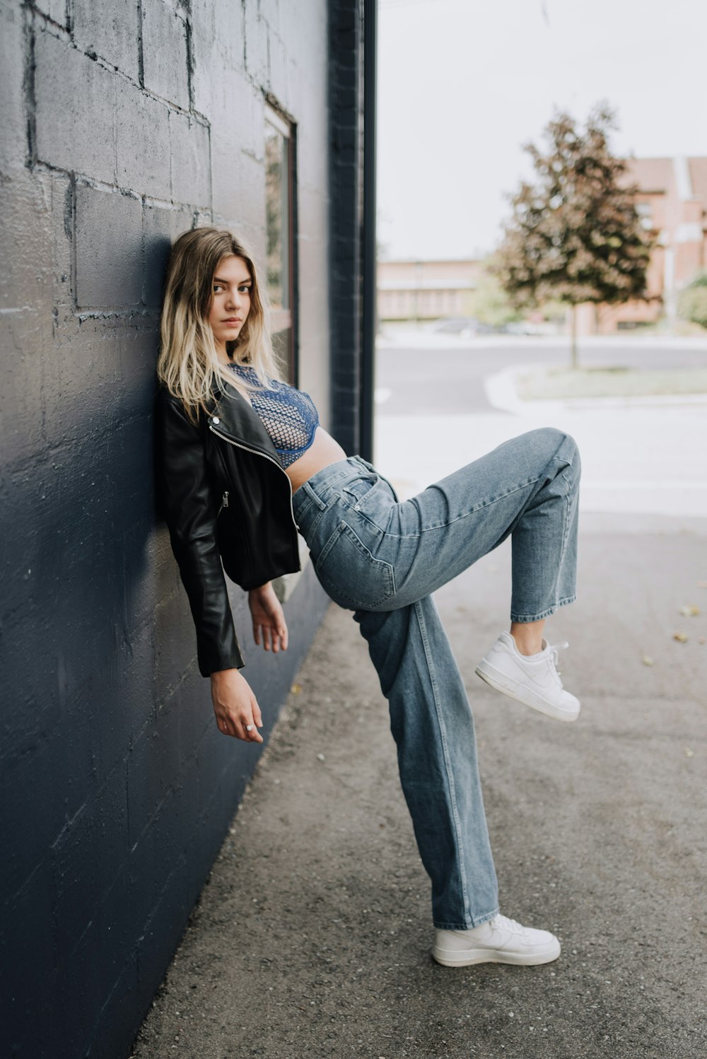 a person leaning against a wall