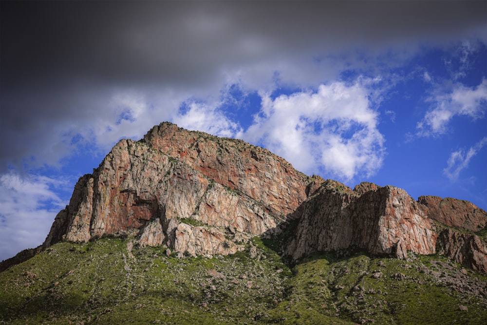 a rocky mountain with clouds