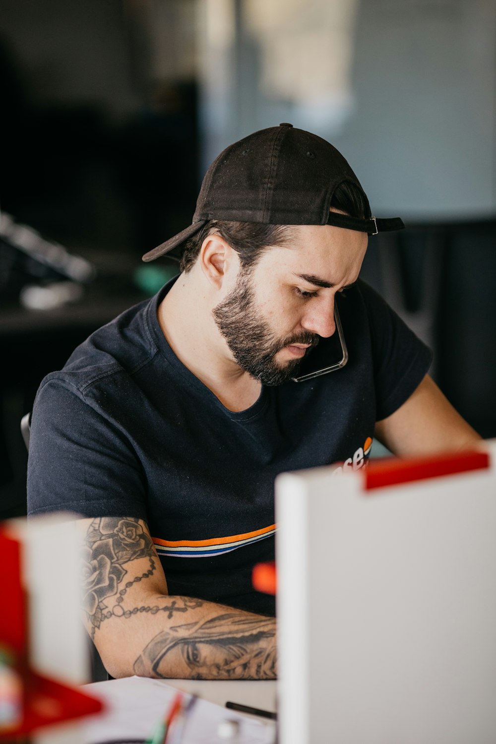 a man with a beard looking at a computer monitor