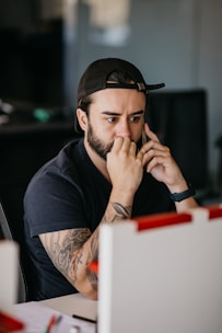 a man with a hat and tattoos