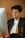 Close-up of a person wearing glasses while working on a laptop.