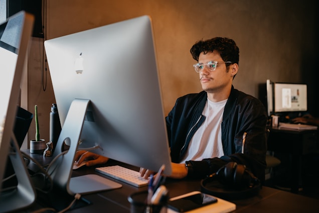 A technician working on a computer in a modern workspace.