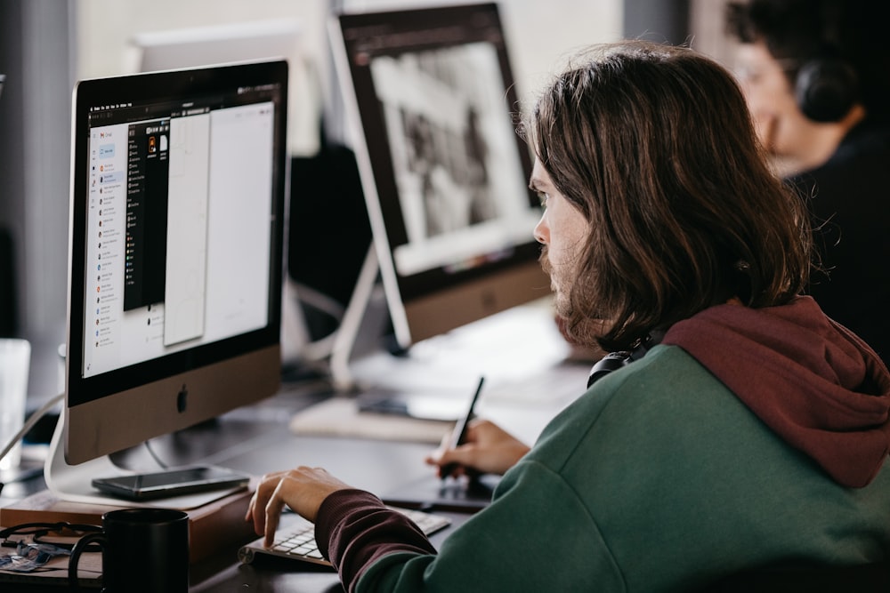 a man and woman looking at a computer screen