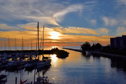 A picturesque sunset over the Sleepy Hollow landscape with boats docked.