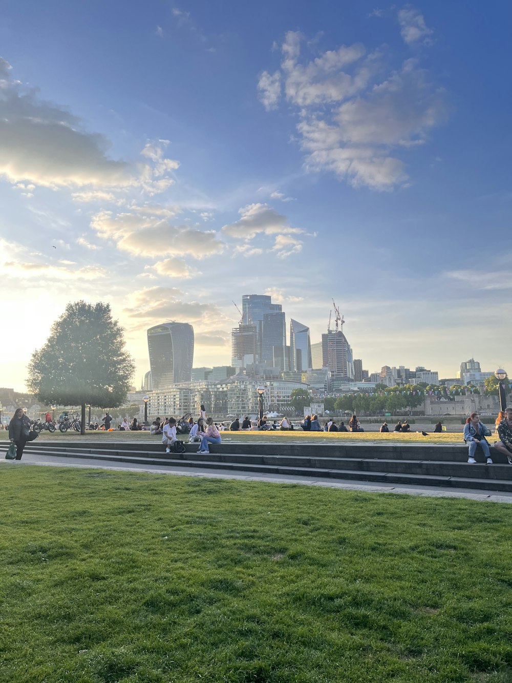 a group of people sitting on a bench in front of a city