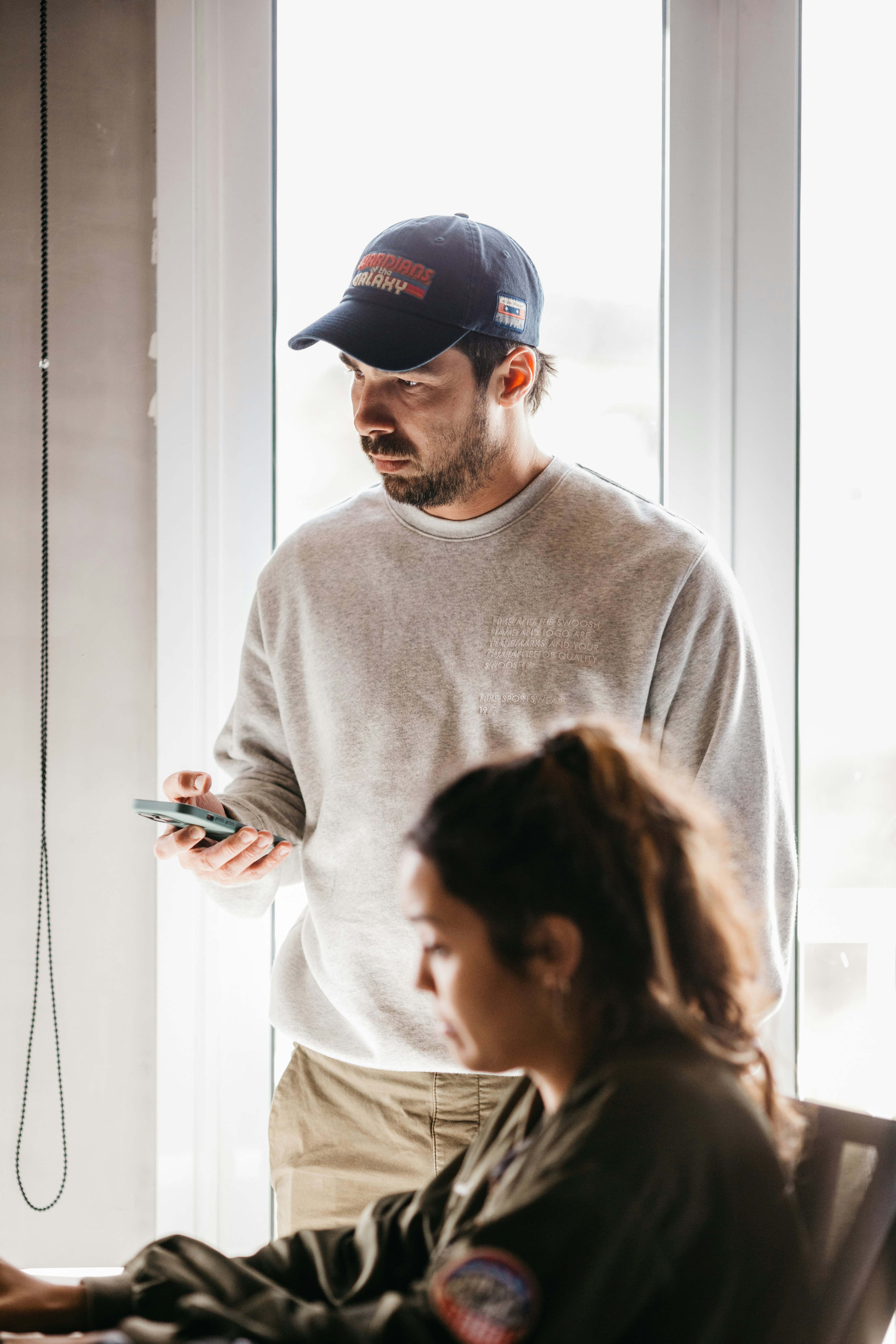 a man and a woman looking at a cell phone
