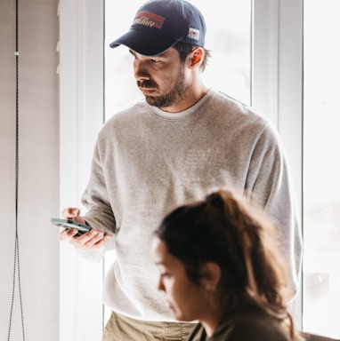 a man and a woman looking at a cell phone