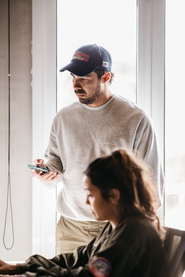 a man and a woman looking at a cell phone