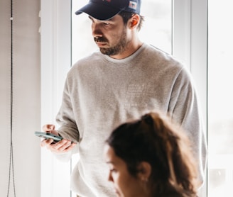 a man and a woman looking at a cell phone