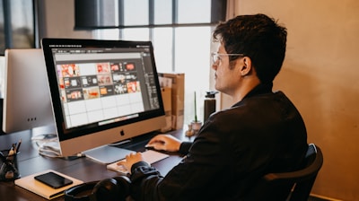 a man sitting at a desk with a computer