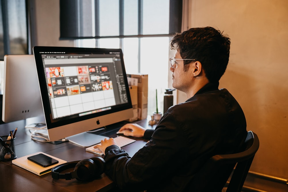 a man sitting at a desk with a computer