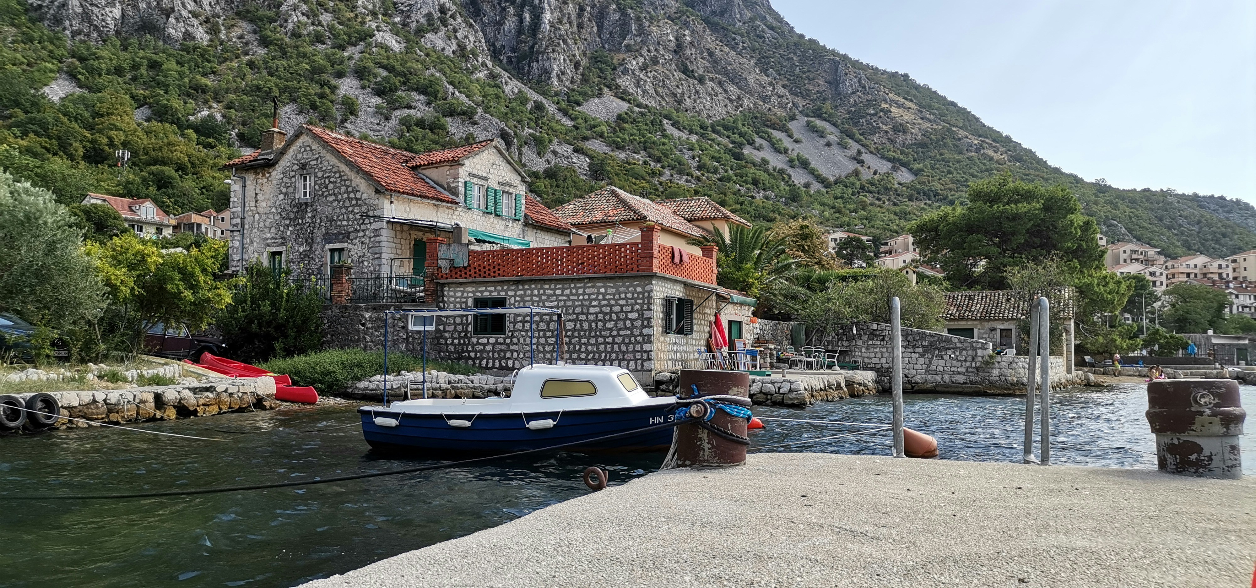 a boat docked at a small village, 