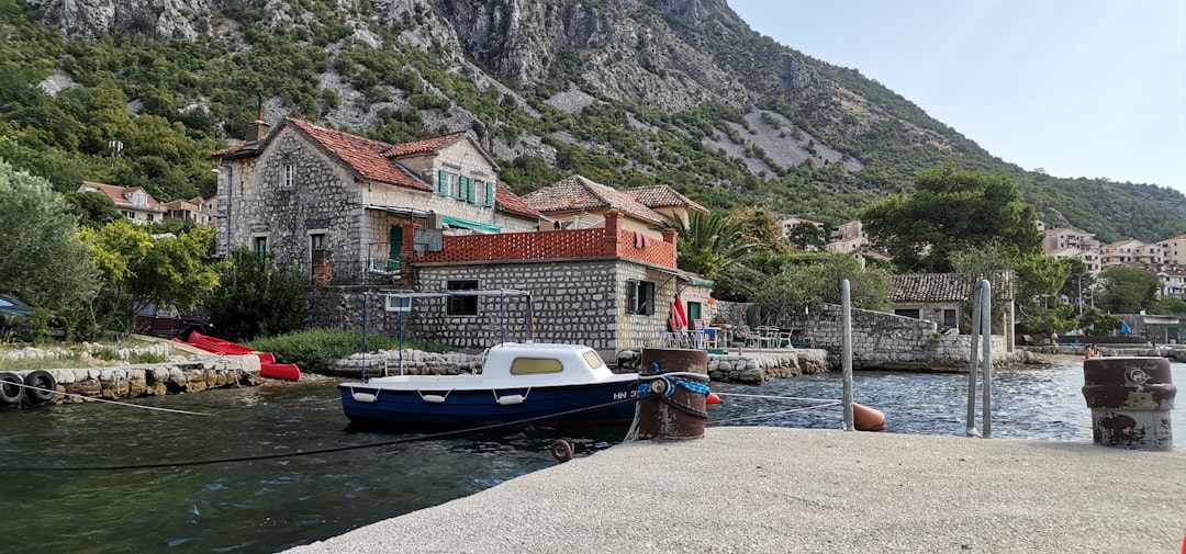 a boat docked at a small village,