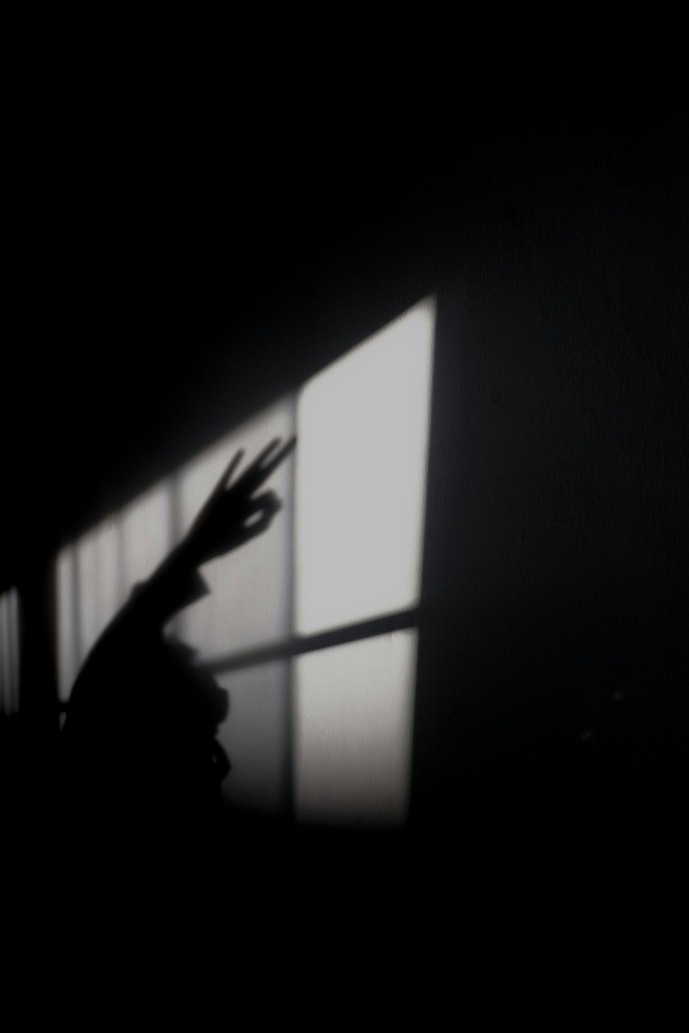 a silhouette of a person holding a clock