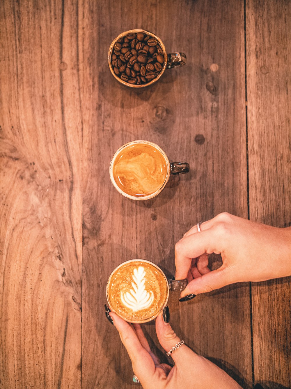 hands holding coffee cups