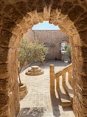 a stone walkway with a fountain
