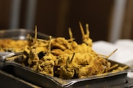 Close-up of grilled skewered meat with aromatic herbs and spices.