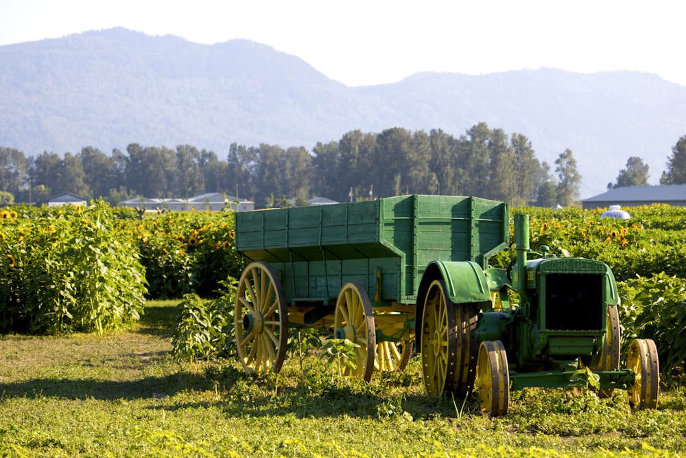 a green farm vehicle in a field