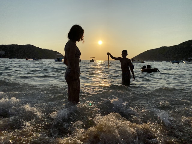 a couple of people standing in water