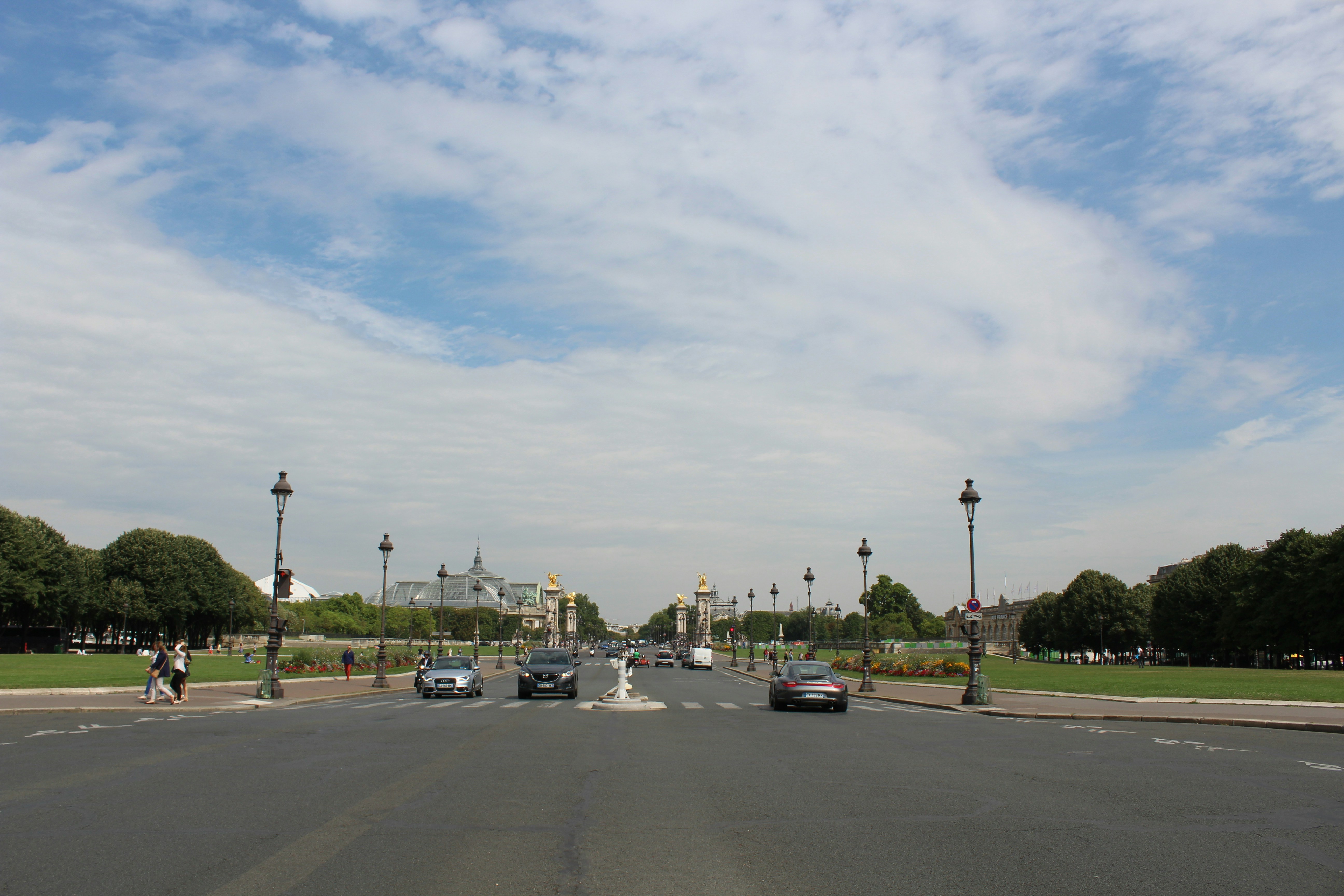 a street with cars and people on it