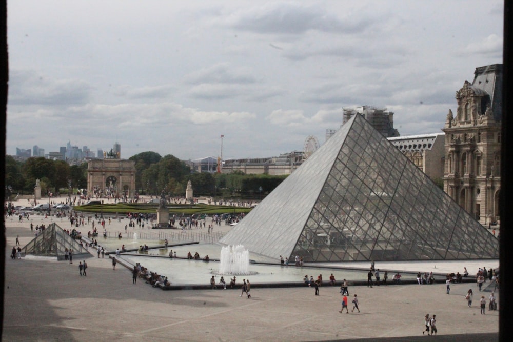 a large glass pyramid in a plaza