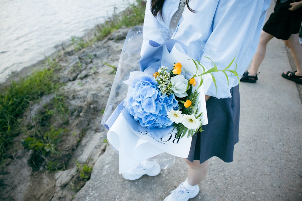 a woman holding a bouquet of flowers