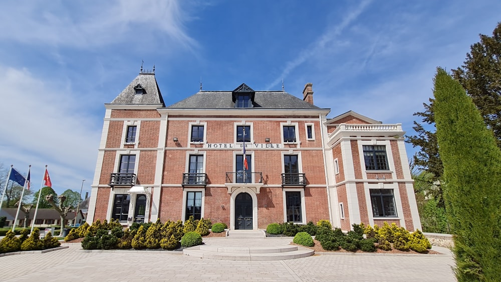 a large brick building with a flag in front of it