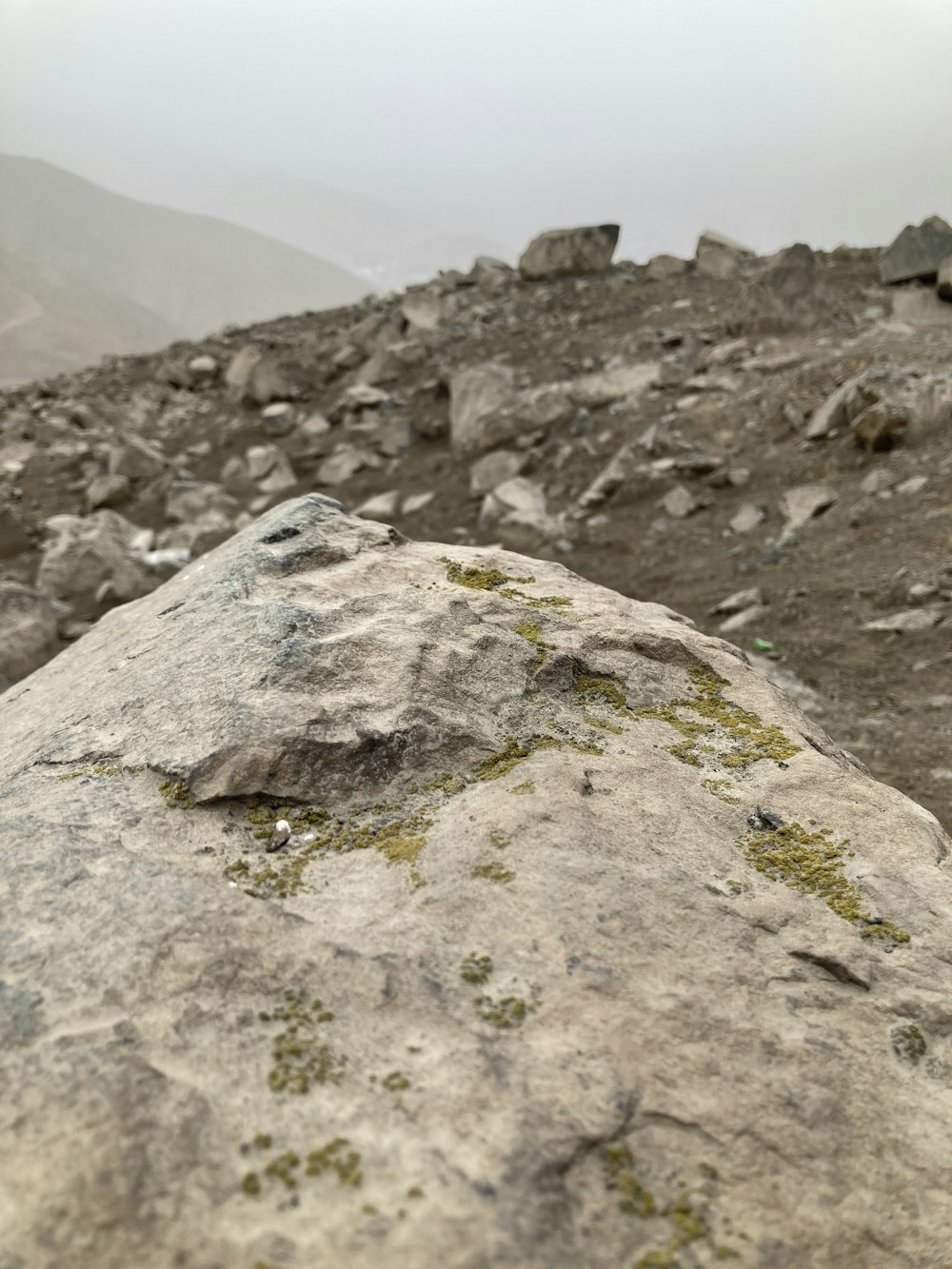 a rocky area with a large rock in the middle