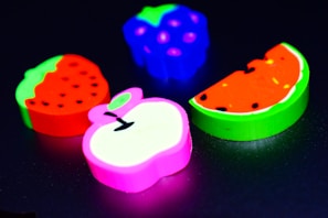 Brightly colored rubber erasers stacked in a playful pile.