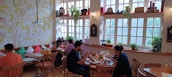 A cozy café interior with customers enjoying their meals.