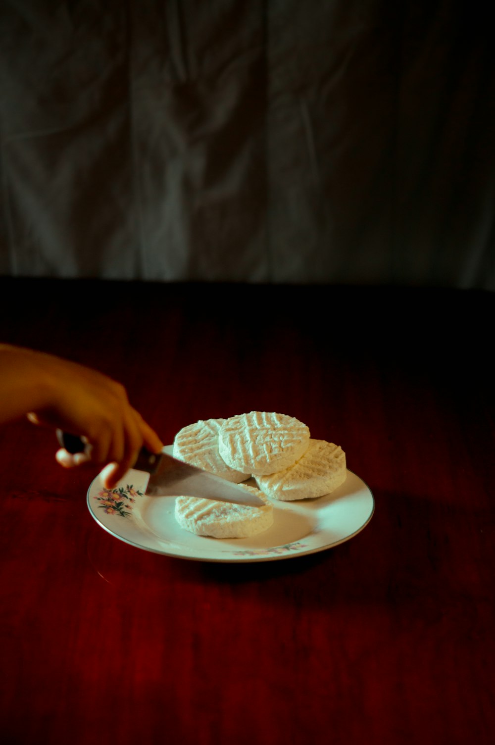 a person cutting a cake