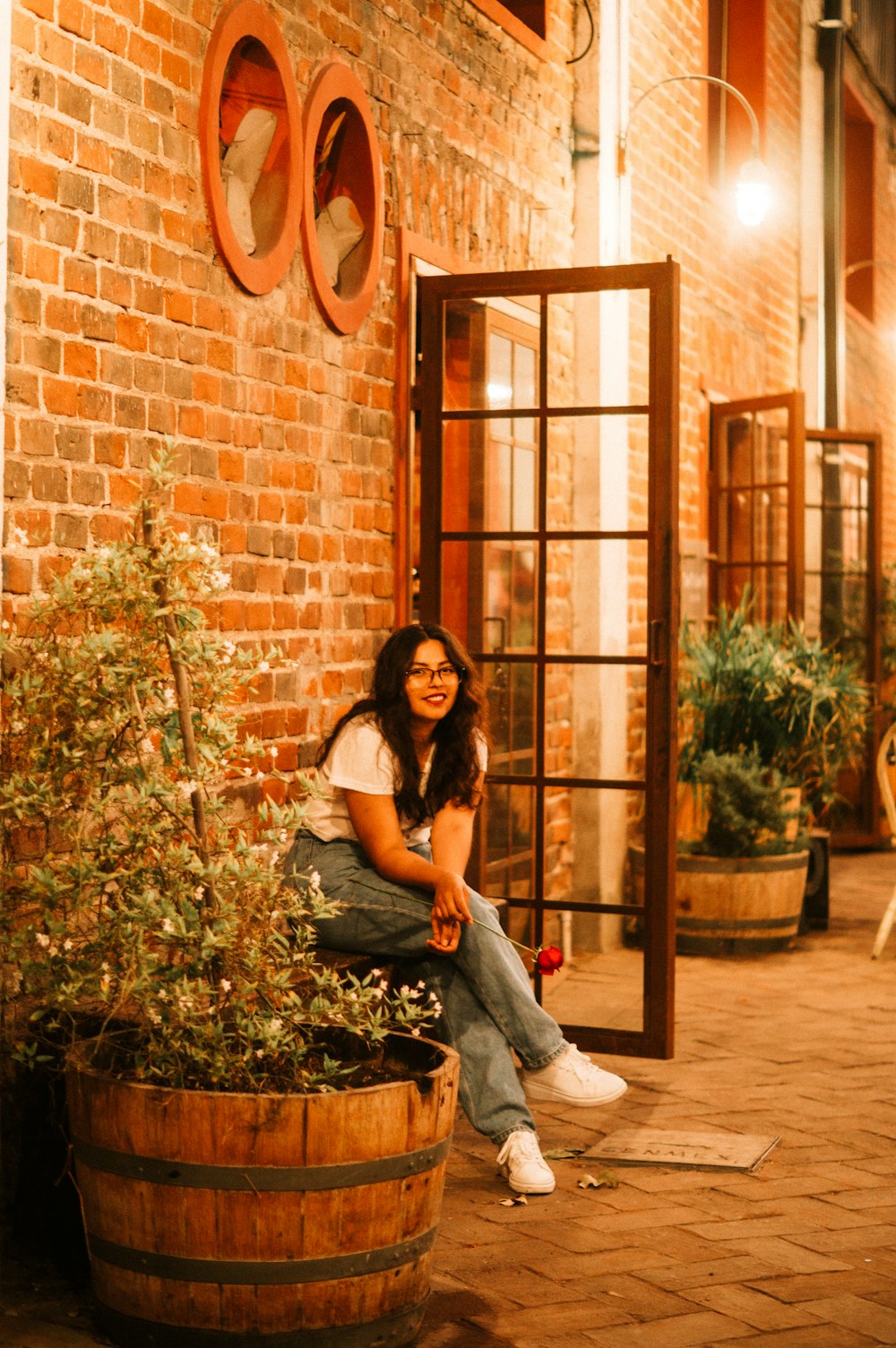 a woman sitting on a barrel