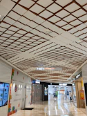 Wide shot of a shopping mall corridor with visible sensor installations on the ceiling.