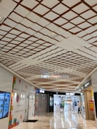 A busy shopping mall with clear directional signage.