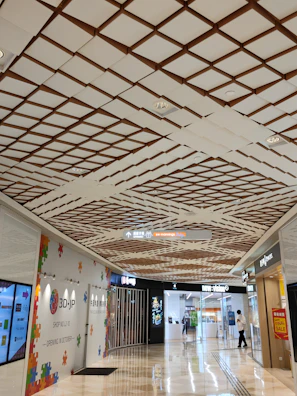 Wide shot of a shopping mall corridor with visible sensor installations on the ceiling.