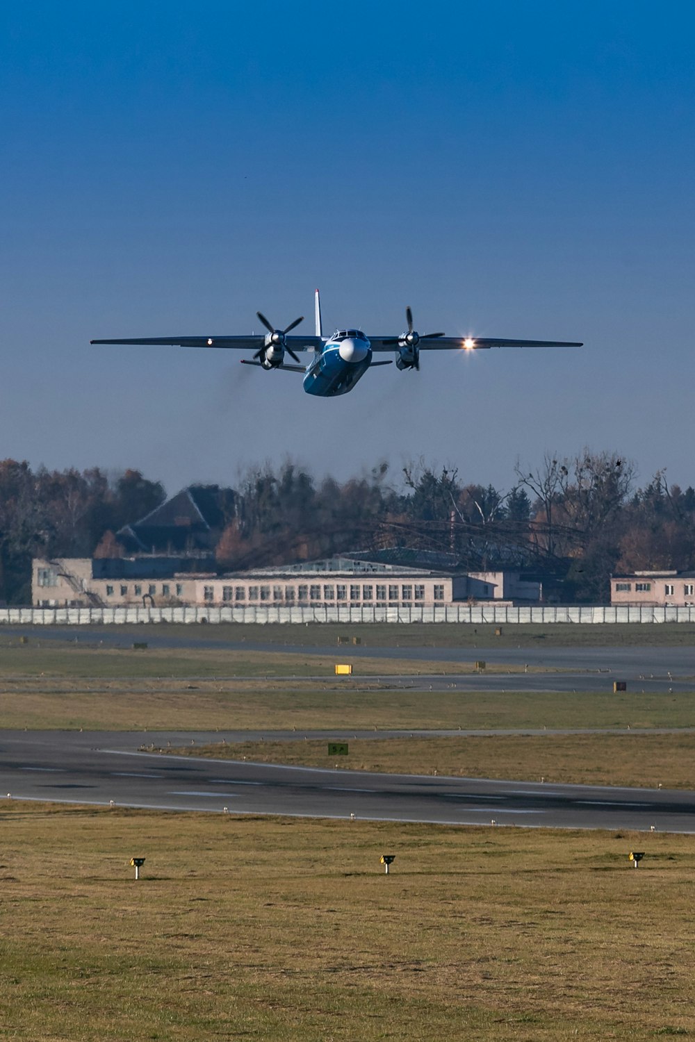 a plane flying over a runway