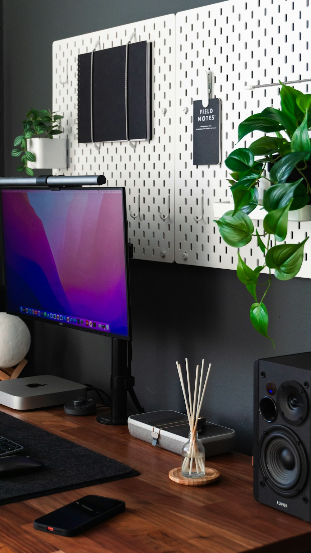 a desk with a computer and speakers