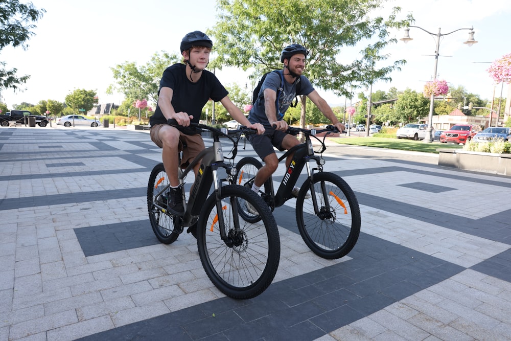 two men riding bikes