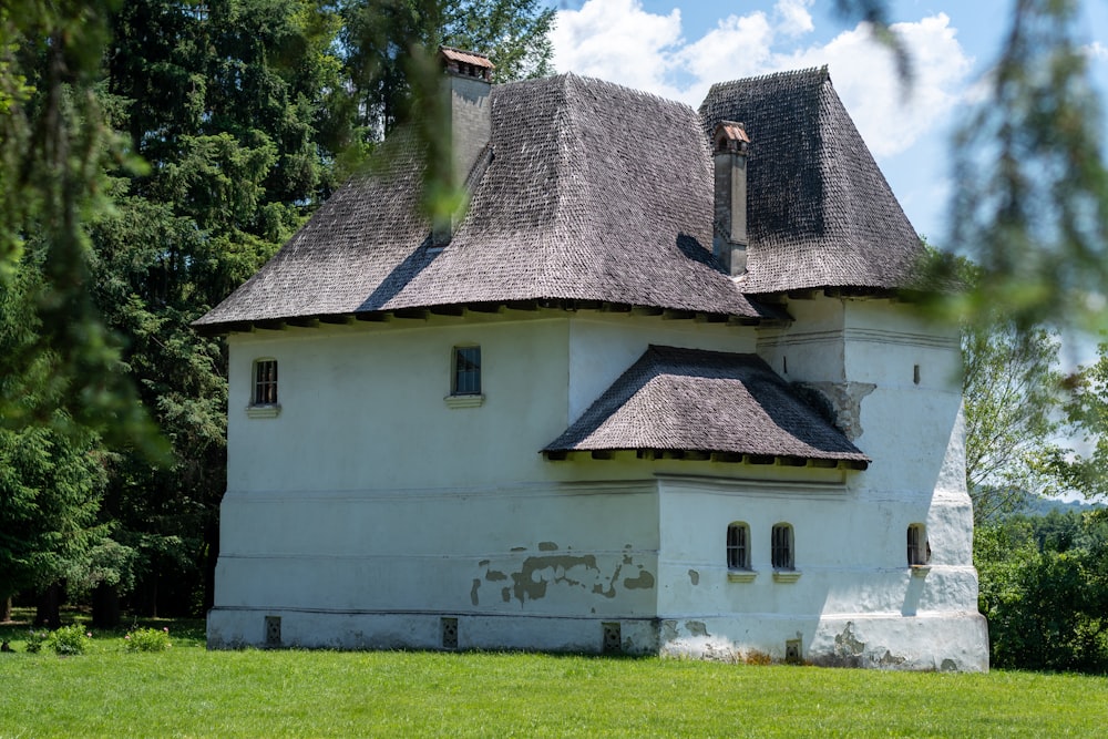 a white house with a grass yard