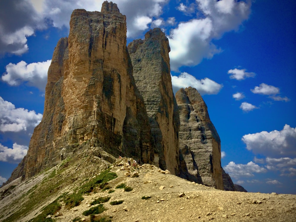 a rocky mountain with a blue sky