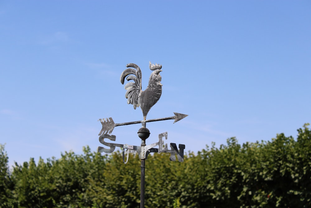 a statue of a bird on a street light